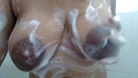 Ebony milf gets naked in the shower and sucks dick