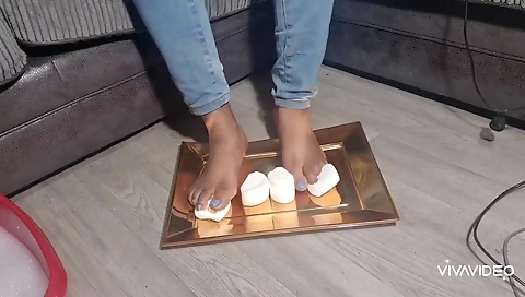 Ebony woman gives her feet and fingers a treat with food