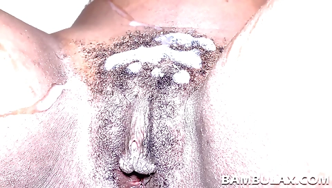 A hairy black pussy is licked and teased by a hard black cock